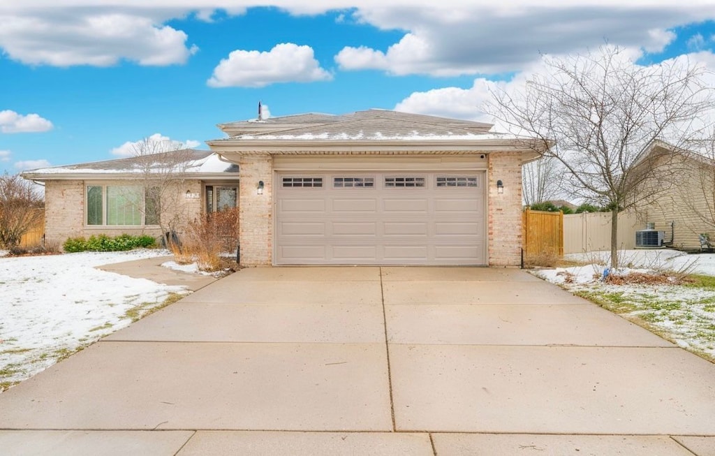 view of front facade with central AC unit and a garage