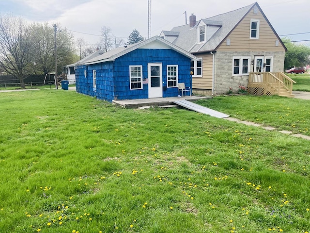 rear view of property with a lawn