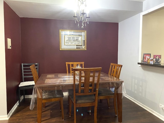 dining area featuring dark hardwood / wood-style flooring and a notable chandelier