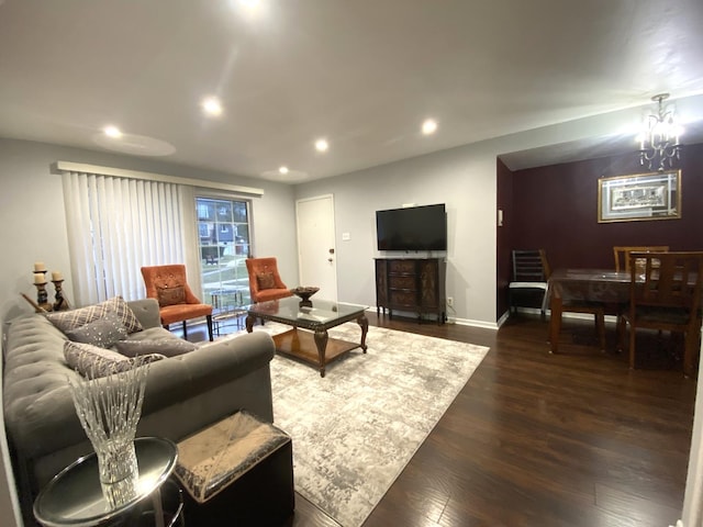 living room featuring dark wood-type flooring and a notable chandelier