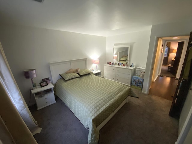 bedroom featuring dark colored carpet