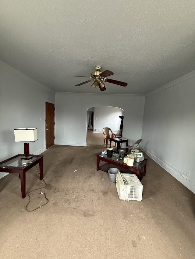 interior space featuring crown molding, carpet flooring, a textured ceiling, and ceiling fan