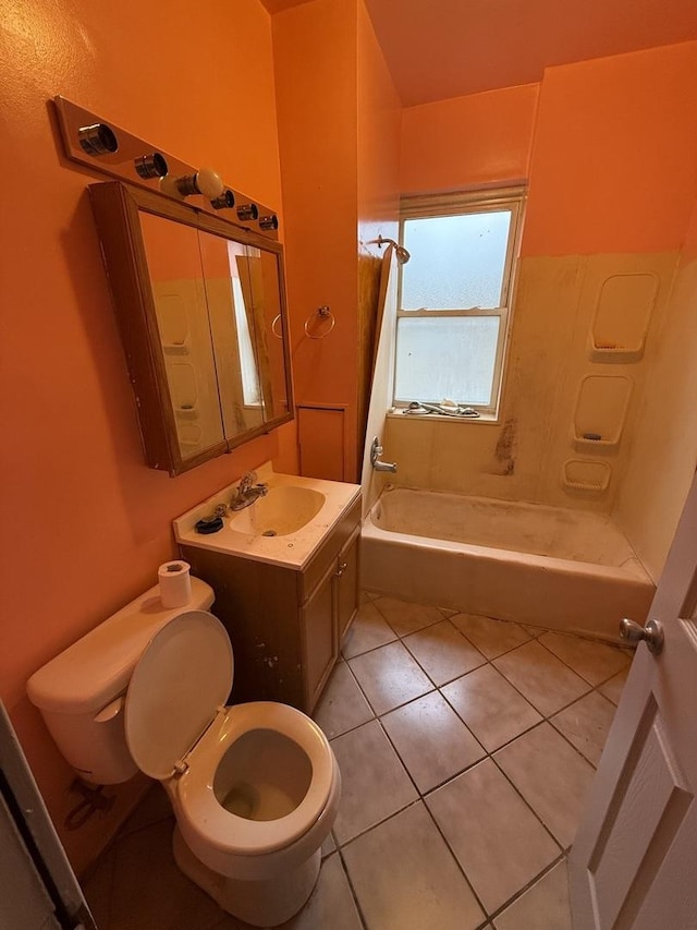 full bathroom with vanity, toilet, tiled shower / bath combo, and tile patterned flooring