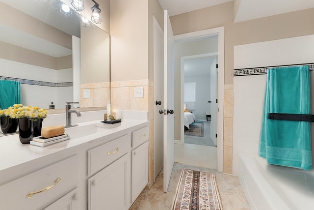 bathroom featuring tile patterned flooring, vanity, and tile walls