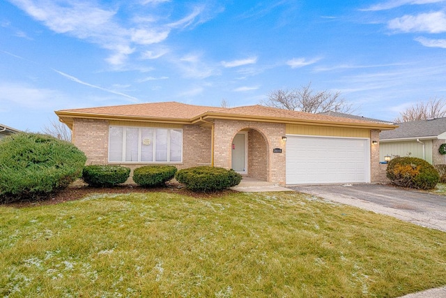 view of front of property with a front lawn and a garage