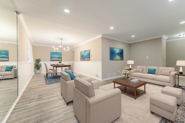 living room with ornamental molding and a notable chandelier