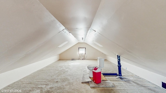 additional living space with carpet flooring and vaulted ceiling