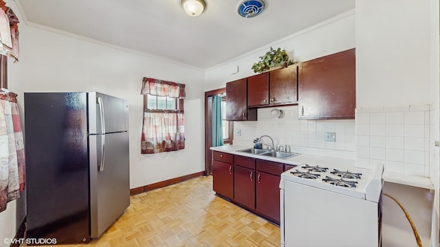 kitchen featuring light parquet flooring, stainless steel refrigerator, ornamental molding, white gas range, and sink