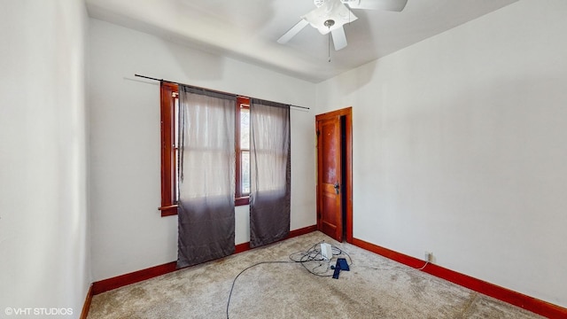 carpeted spare room with ceiling fan