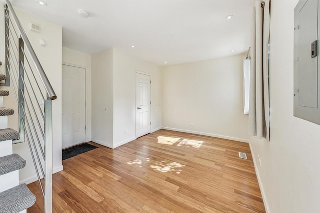 interior space with electric panel and light wood-type flooring