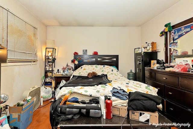 bedroom with hardwood / wood-style flooring