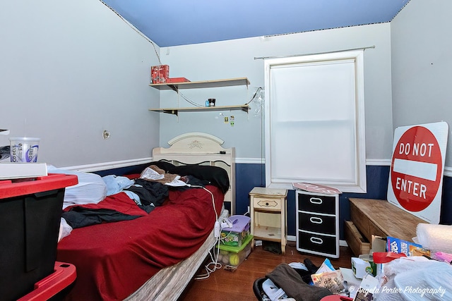 bedroom with dark wood-type flooring