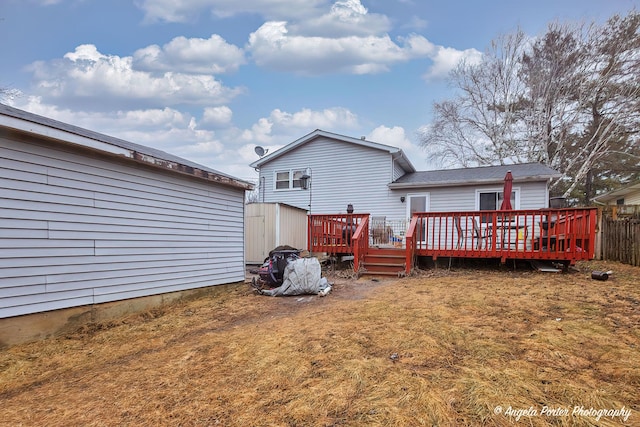 rear view of house with a yard and a deck