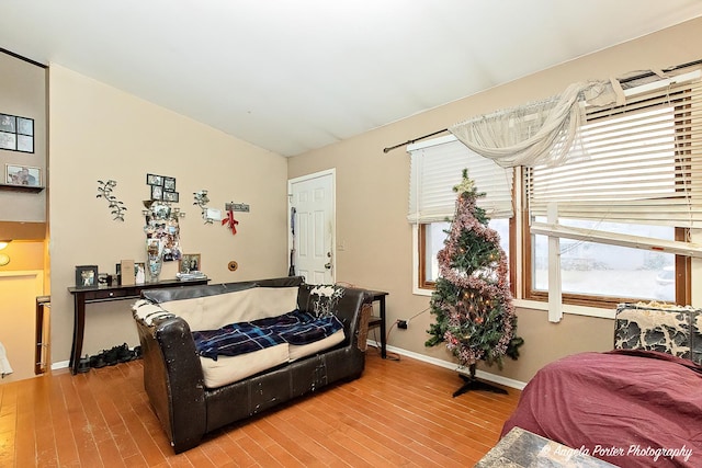 bedroom featuring hardwood / wood-style flooring and vaulted ceiling