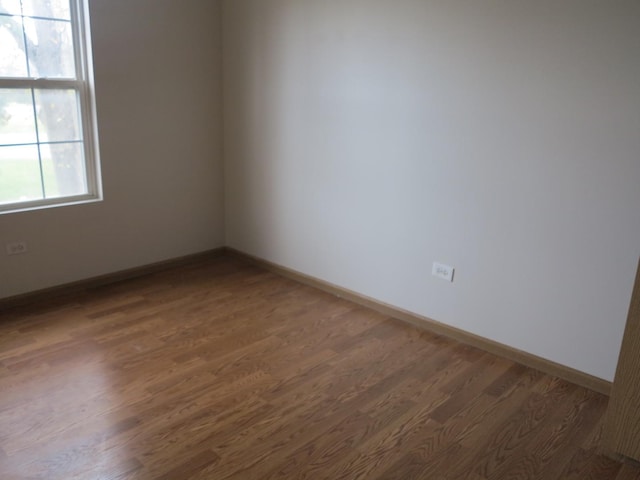 unfurnished room featuring dark hardwood / wood-style floors