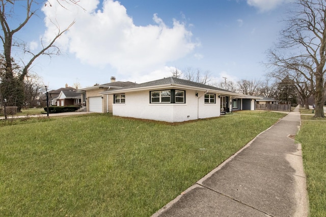 view of front of property with a garage and a front lawn