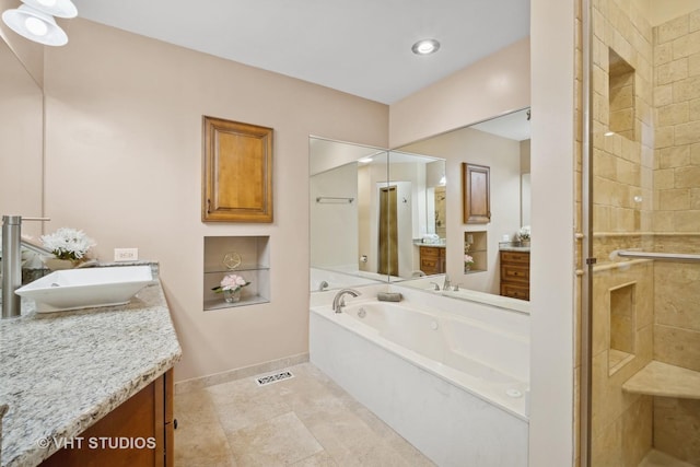 bathroom with tile patterned flooring, vanity, and independent shower and bath