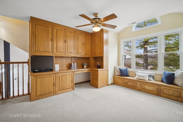 office space featuring light carpet, ceiling fan, and vaulted ceiling