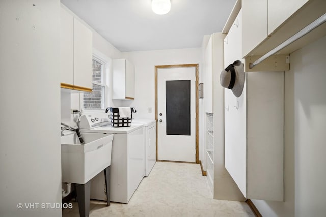 washroom with cabinets, separate washer and dryer, and sink