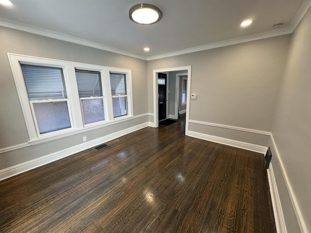 spare room featuring dark hardwood / wood-style flooring and ornamental molding