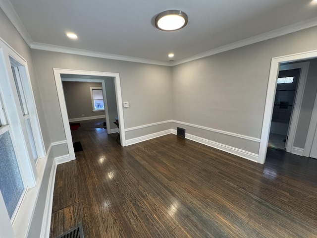 unfurnished room with dark hardwood / wood-style flooring and ornamental molding