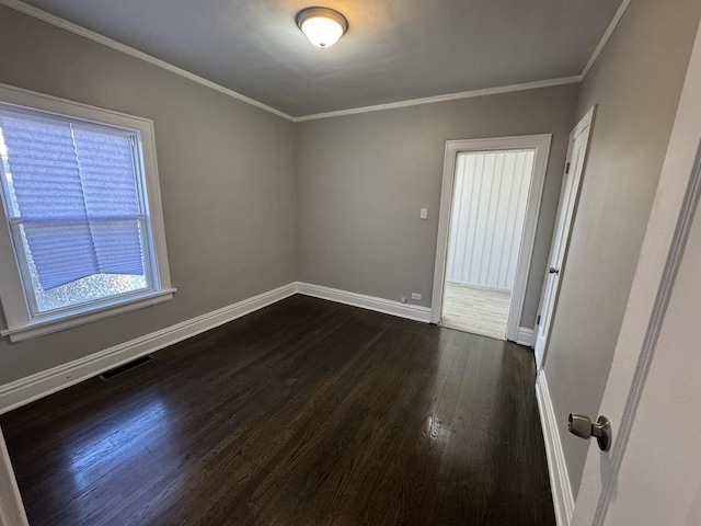 unfurnished room with crown molding and dark wood-type flooring