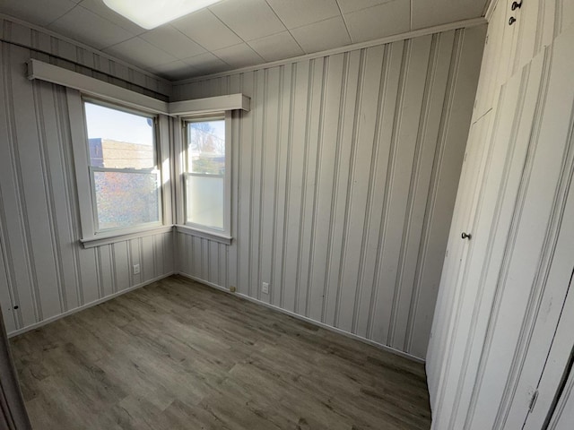 empty room with wood-type flooring and a barn door