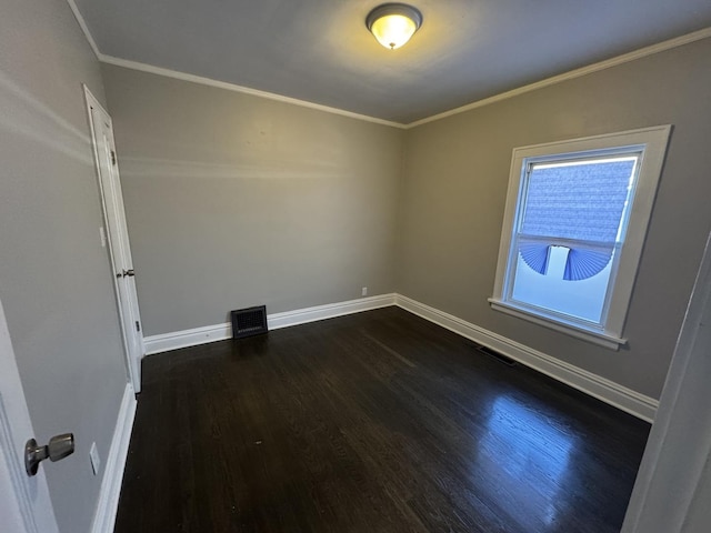 spare room with dark hardwood / wood-style floors and crown molding