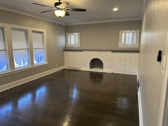 unfurnished living room with a brick fireplace, ceiling fan, dark hardwood / wood-style flooring, and ornamental molding