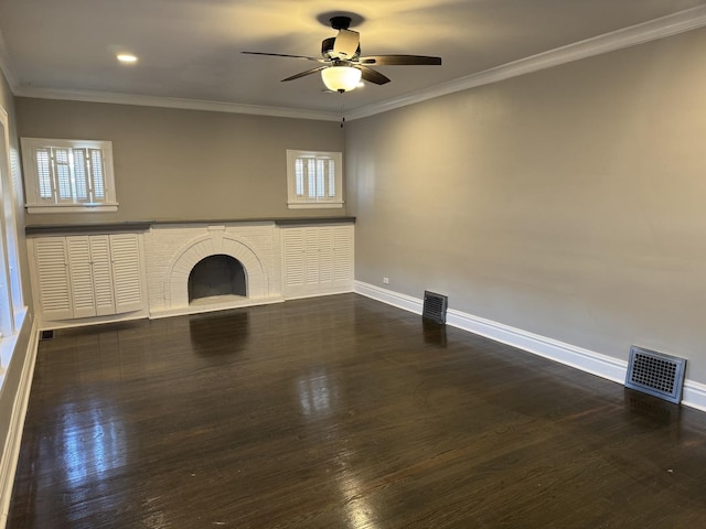 unfurnished living room featuring crown molding, a fireplace, ceiling fan, and dark hardwood / wood-style floors