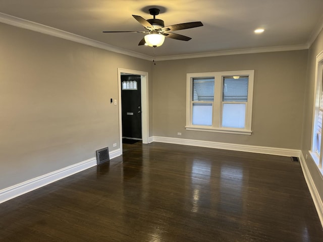 spare room with ceiling fan, ornamental molding, and dark wood-type flooring