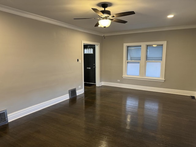 spare room with ceiling fan, dark hardwood / wood-style floors, and ornamental molding