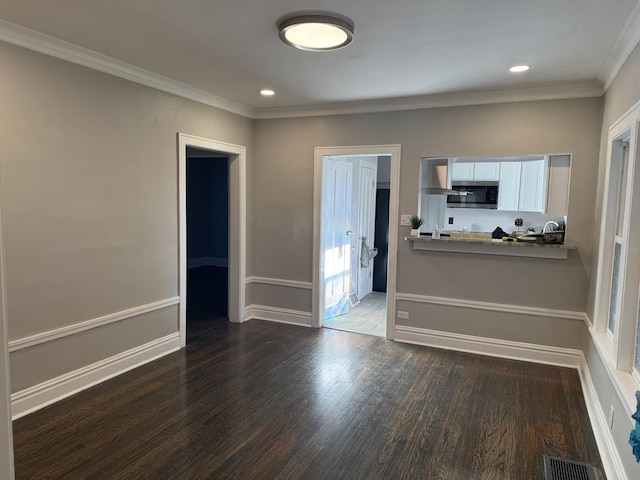 kitchen with white cabinetry, dark wood-type flooring, and crown molding