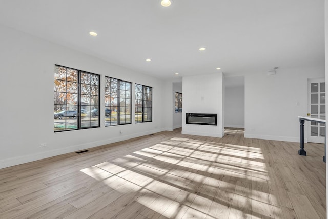 unfurnished living room featuring light wood-type flooring