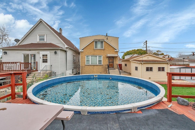 view of pool featuring a wooden deck and an outdoor structure