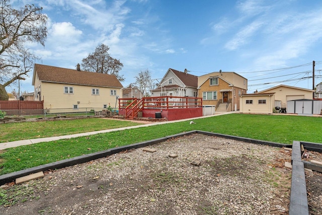 back of property with a deck and a lawn