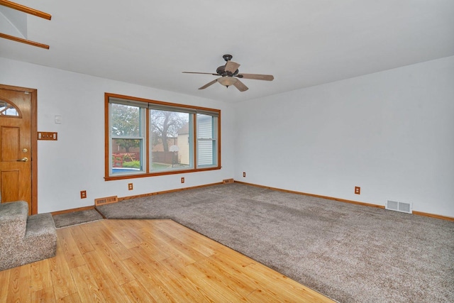 unfurnished living room featuring wood-type flooring and ceiling fan