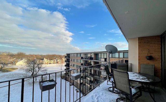 view of snow covered back of property