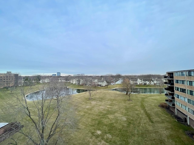 view of community with a lawn and a water view