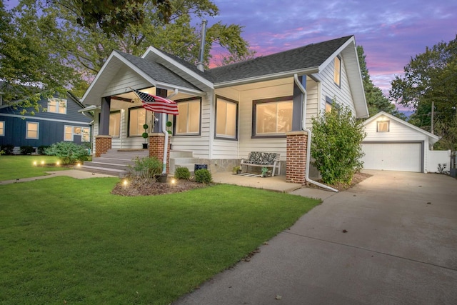 craftsman-style house featuring a porch, a garage, an outdoor structure, and a lawn