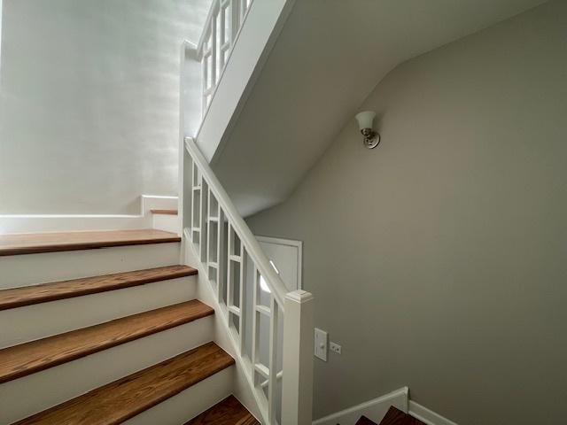 stairway with vaulted ceiling