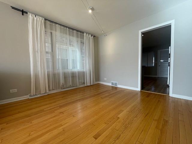 unfurnished room with light hardwood / wood-style floors