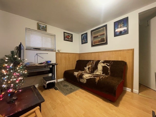 living room featuring light hardwood / wood-style floors and wood walls