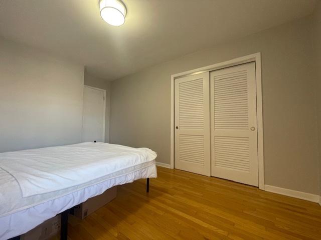 bedroom featuring light hardwood / wood-style floors and a closet