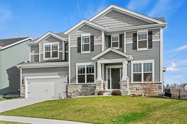 craftsman-style house with concrete driveway, stone siding, an attached garage, fence, and a front lawn