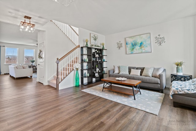 living area featuring stairs and wood finished floors