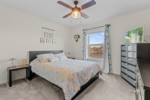 bedroom with baseboards, ceiling fan, and light colored carpet