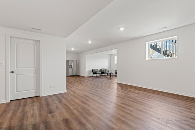 unfurnished living room with recessed lighting, visible vents, baseboards, and wood finished floors