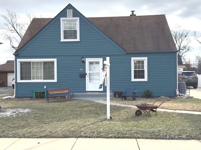 cape cod home with a front yard