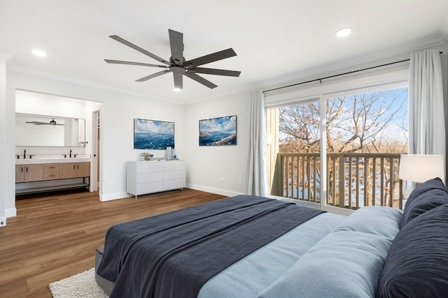 bedroom with wood-type flooring, sink, ornamental molding, access to outside, and ensuite bath